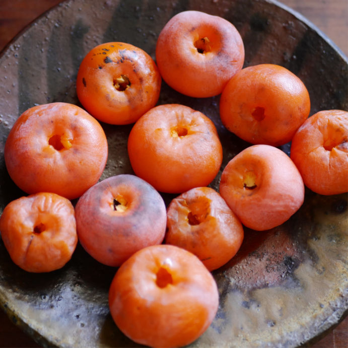 Persimmons on a clay plate